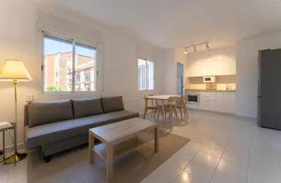 a living room with a couch and a table at Winahost Barcelona Sants in Barcelona