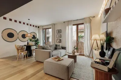 a mirror in a living room with a couch and a table at Mawun - 2 bedrooms in Gràcia in Barcelona