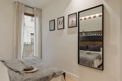 a bedroom with a bed and a picture on the wall at Mawun - 2 bedrooms in Gràcia in Barcelona