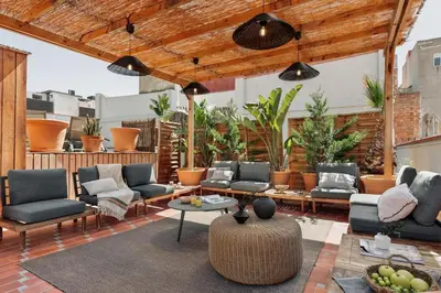 an outdoor patio with couches and a table at Oetune - 2 bedrooms and office in Gràcia in Barcelona