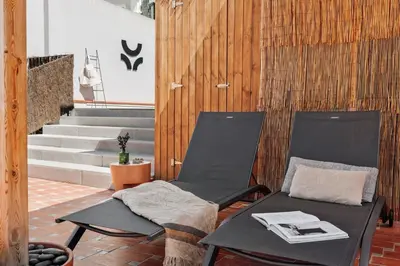 a couch sitting on a patio with potted plants at Oetune - 2 bedrooms and office in Gràcia in Barcelona