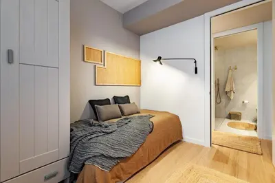 a kitchen with a sink and a couch in a room at Sanur - 2 bedrooms in Gràcia in Barcelona