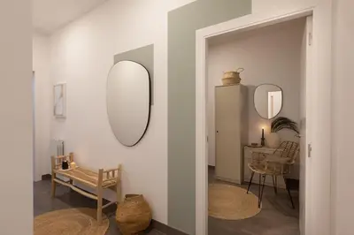 a kitchen and living room with a couch and a table at Damar - 2 bedrooms and balcony in Eixample Dreta in Barcelona