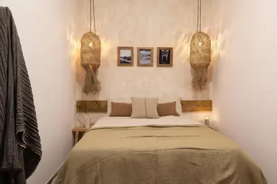 a bedroom with a bed with a potted plant and a lamp at Damar - 2 bedrooms and balcony in Eixample Dreta in Barcelona