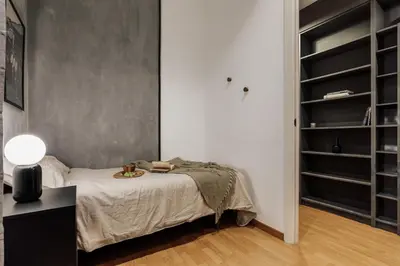 a book shelf filled with lots of books and candles at Yari - 3 bedrooms and terrace in Sant Gervasi in Barcelona