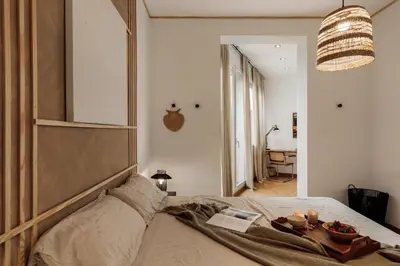 a bedroom with a bed and a wooden cabinet at Yari - 3 bedrooms and terrace in Sant Gervasi in Barcelona