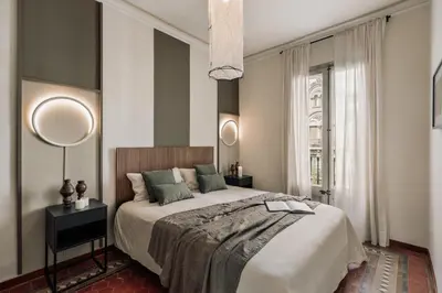 a bedroom with a large white bed with two lamps at Cotoca - 3 bedrooms and balcony in Eixample Dreta in Barcelona