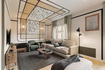 a living room with a couch and a table at Kadikoy - 4 bedrooms and terrace in Sant Gervasi in Barcelona