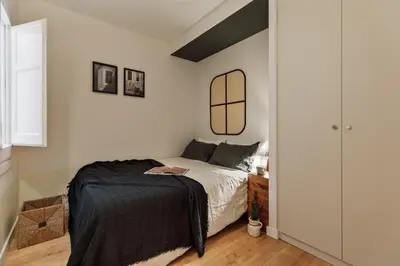 a kitchen with white cabinets and black counters at Kadikoy - 4 bedrooms and terrace in Sant Gervasi in Barcelona