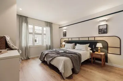 a bedroom with a bed and a table with a lamp at Kadikoy - 4 bedrooms and terrace in Sant Gervasi in Barcelona