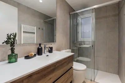 a bathroom with a sink and a toilet and a shower at Kadikoy - 4 bedrooms and terrace in Sant Gervasi in Barcelona