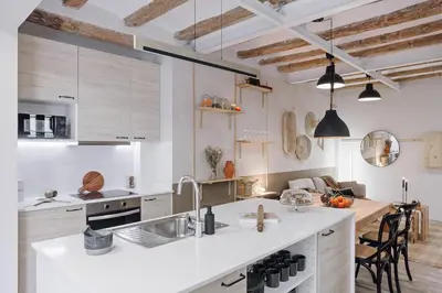 a table with chairs and a table with a candle at Velez - 1 bedroom in Gràcia in Barcelona