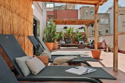 two chairs and a table in a room with stairs at Mojo - 2 bedrooms in Gràcia in Barcelona