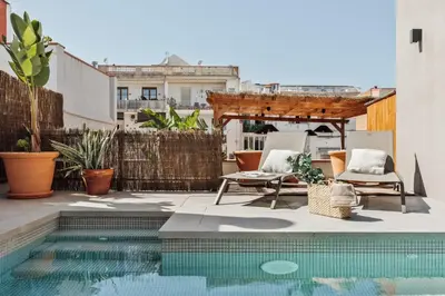 a potted plant sitting next to a swimming pool at Mojo - 2 bedrooms in Gràcia in Barcelona