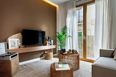a living room with a flat screen tv and a couch at Mojo - 2 bedrooms in Gràcia in Barcelona