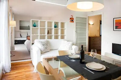 a living room with a white couch and a table at Attic with terrace Barcelona center in Barcelona