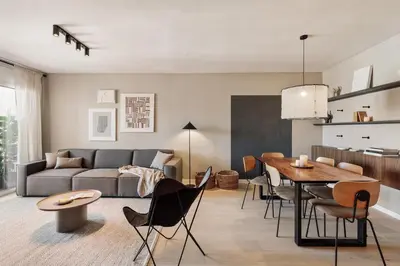 a living room with a dining table and a television at Katz - 3 bedrooms and terrace in Les Corts in Barcelona