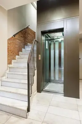 a staircase in a building with a brick wall at Balcón, WiFi y aire acondicionado en Plaza Cataluña in Barcelona