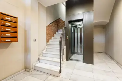 a hallway with stairs and a brick wall at Balcón, WiFi y aire acondicionado en Plaza Cataluña in Barcelona