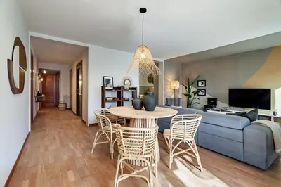 a living room with a couch and a table and chairs at Sipura - 3 bedrooms and balcony in Eixample Dreta in Barcelona