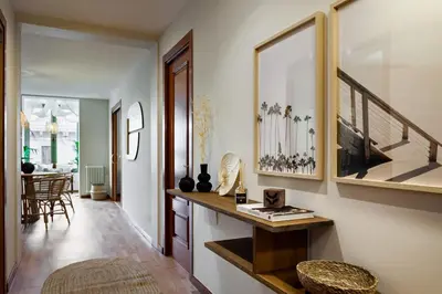 a living room with a hallway with a table and stairs at Sipura - 3 bedrooms and balcony in Eixample Dreta in Barcelona