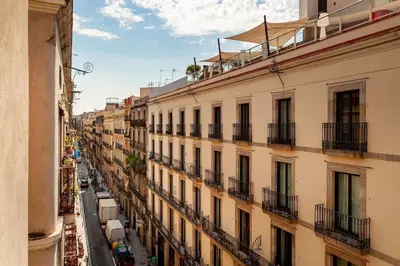 a bedroom with a bed and a dresser with a mirror at Shan - 1 bedroom and balcony in El Born in Barcelona