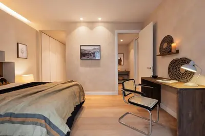 a bedroom with a large bed with two lamps at Merzouga - 1 bedroom, a pool and terrace in Gràcia in Barcelona