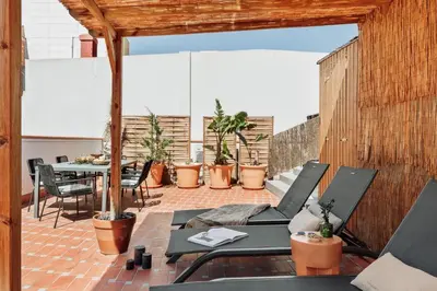 a patio with a table and chairs and stairs at Merzouga - 1 bedroom, a pool and terrace in Gràcia in Barcelona