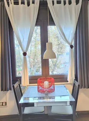 a table with a lamp in front of a window at Barcelona Badalona tu refugio playa y metro in Badalona