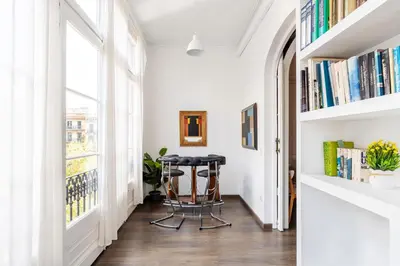 a hallway with a table and bookshelves at Apartamento Premium 5 Hab con Balcón a Gran Vía - Grupos hasta 10 - Passeig Gràcia 7min in Barcelona