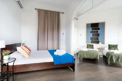 a bedroom with a large bed and a table at Apartamento Premium 5 Hab con Balcón a Gran Vía - Grupos hasta 10 - Passeig Gràcia 7min in Barcelona