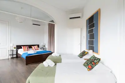 a bedroom with two beds and a bed with pillows at Apartamento Premium 5 Hab con Balcón a Gran Vía - Grupos hasta 10 - Passeig Gràcia 7min in Barcelona