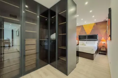 a bedroom with a bed and a large glass closet at Comfort, Style & Value near Barceloneta Beaches in Barcelona