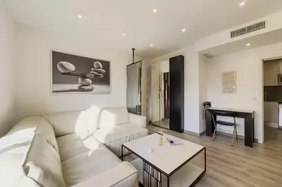 a living room with a white couch and a table at Comfort, Style & Value near Barceloneta Beaches in Barcelona