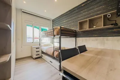 a bedroom with two bunk beds and a wooden floor at Comfort, Style & Value near Barceloneta Beaches in Barcelona