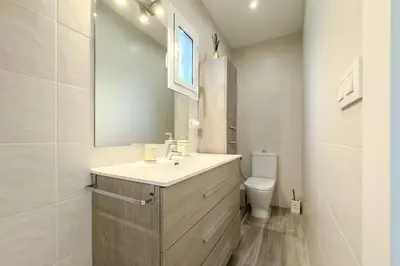 a bathroom with a sink and a toilet and a mirror at Comfort, Style & Value near Barceloneta Beaches in Barcelona