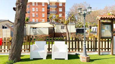 a bedroom with two bunk beds and a window at Camping Costa Dorada Tienda Lua in Canet de Mar