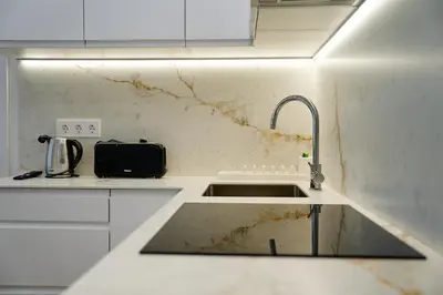 a kitchen with a sink and a dirty wall at Apartamentos Valentin in Barcelona