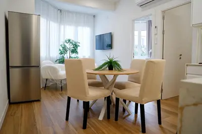 a kitchen and dining room with a table and chairs at Apartamentos Valentin in Barcelona