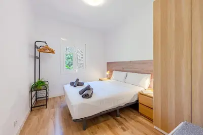 a bedroom with a white bed and a window at Key Barcelona Sagrada Familia House Terrace in Barcelona