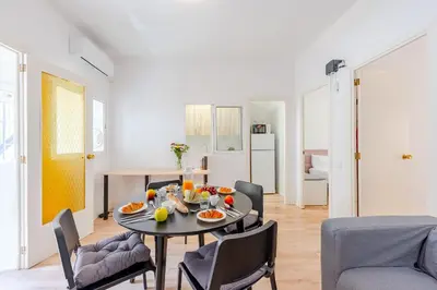 a dining room with a table and chairs in a room at Key Barcelona Sagrada Familia House Terrace in Barcelona