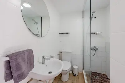 a white bathroom with a sink and a mirror at Key Barcelona Sagrada Familia House Terrace in Barcelona