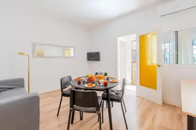 a dining room and living room with a table and chairs at Key Barcelona Sagrada Familia House Terrace in Barcelona