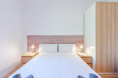 a bedroom with a large white bed with two lamps at Key Barcelona Sagrada Familia House Terrace in Barcelona