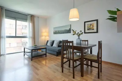 a living room with a table and a couch at 1IND1011 - One bedroom apartment in Barcelona