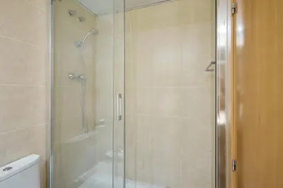 a shower stall with a glass door in a bathroom at 1IND1011 - One bedroom apartment in Barcelona