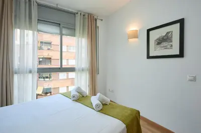 a bedroom with a bed and a large window at 1IND1011 - One bedroom apartment in Barcelona