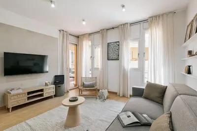 a bathroom with a tub and a toilet and a sink at Agnello - 3 bedrooms and office in Sant Gervasi in Barcelona