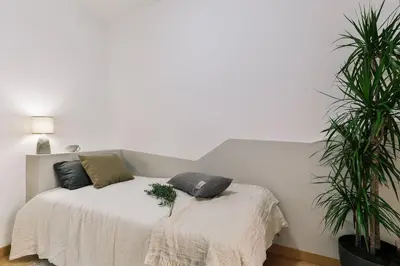 a bedroom with a bed with two pillows on it at Agnello - 3 bedrooms and office in Sant Gervasi in Barcelona