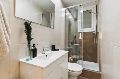 a living room with a couch and a tv at Agnello - 3 bedrooms and office in Sant Gervasi in Barcelona
